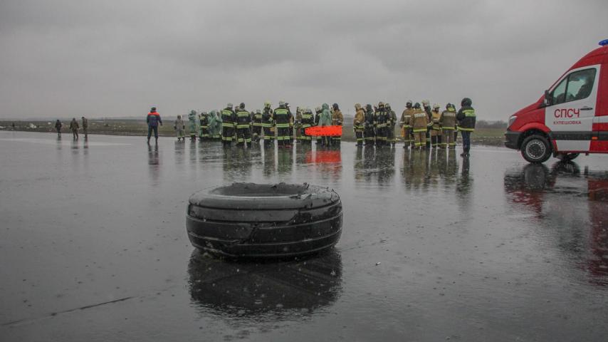 Los bomberos en la pista de aterrizaje tras el accidente.