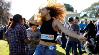 Bernie Sanders supporter Drew Rainer dances prior to the presidential candidate's campaign rally at Colton Hall in Monterey