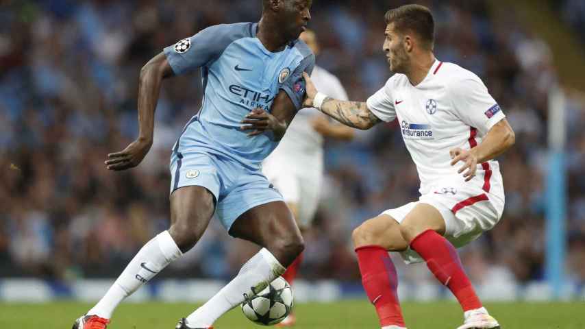 Manchester City's Yaya Toure in action with Steaua Bucharest's Ovidiu Popescu