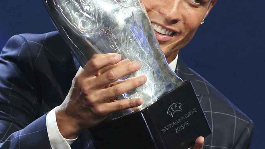 Real Madrid's Cristiano Ronaldo of Portugal reacts as he receives the Best Player UEFA 2015/16 Award during the draw ceremony for the 2016/2017 Champions League Cup soccer competition at Monaco's Grimaldi in Monaco