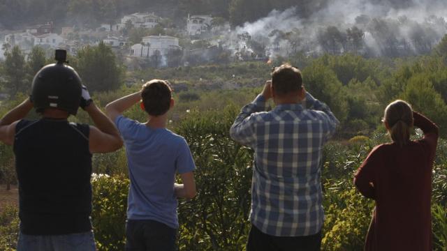 Vecinos observan la evolución del incendio forestal en la zona de Villes del Vent, Benitatxell.