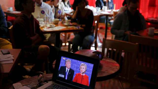 Un espectador, en un bar, sigue el debate de Clinton-Trump en un ordenador.