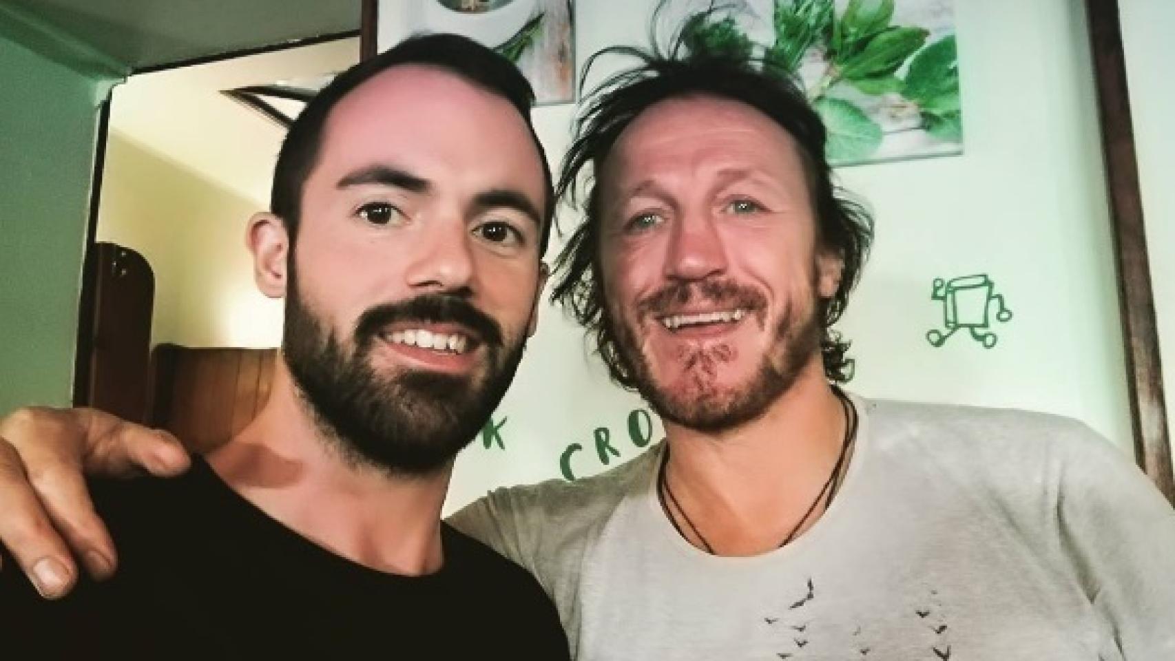 Flynn posa junto al dueño del restaurante vegetariano.