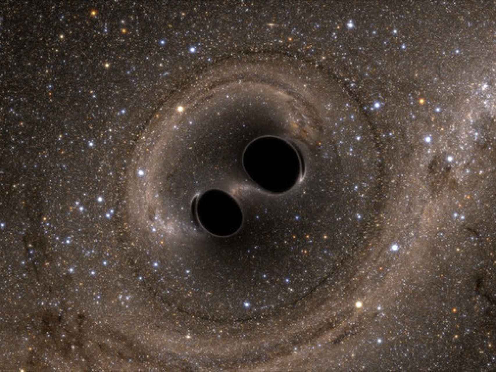 Dos agujeros negros a punto de ser absorbidos.