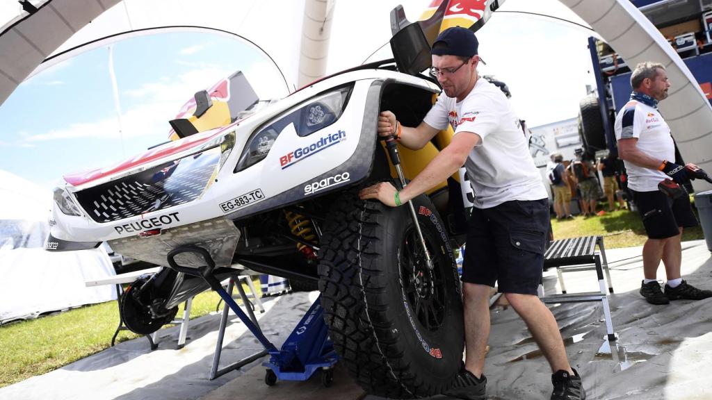 Un mecánico prepara uno de los Peugeot antes de las verificaciones técnicas.