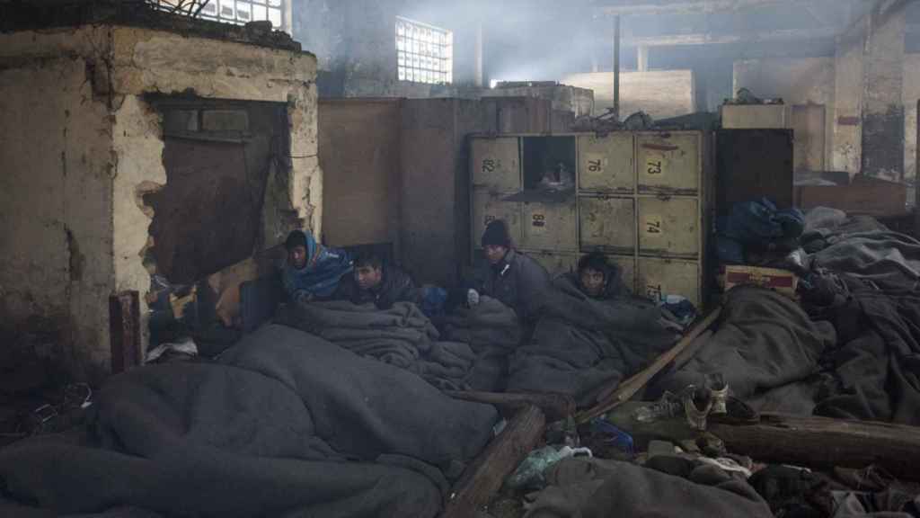 Un grupo de refugiados afganos descansan en el interior de unos almacenes abandonados a unos 10 minutos del centro de Belgrado, Serbia