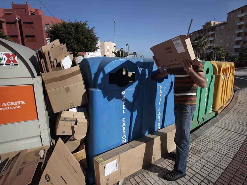 Un vecino deposita una caja de cartón en Santa Cruz de Tenerife.