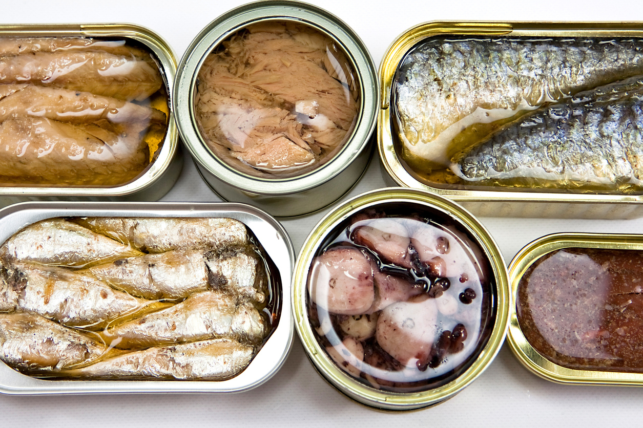 Tin cans full of seafood type foods like tuna and sardines