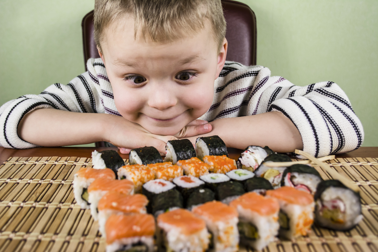 boy looks at sushi