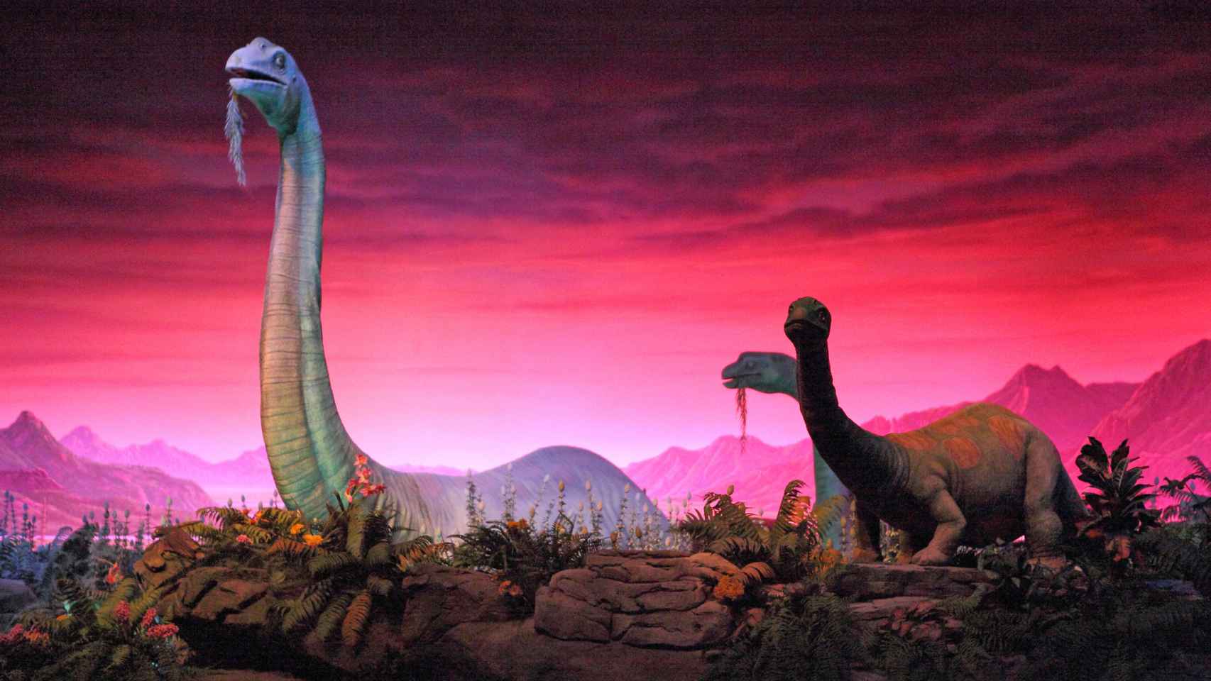 Ilustración en la que aparecen dinosaurios saurópodos.