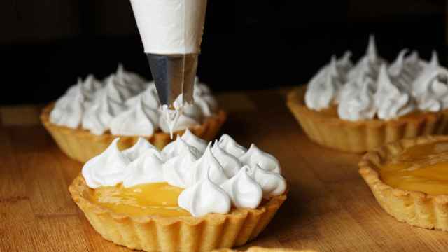 Delicious lemon curd tartlets  with meringue on wooden  table