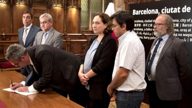 Ada Colau (c), alcaldesa de Barcelona, asiste a la firma del libro de condolencias del 'conseller' de Interior, Joaquim Forn (2i), junto a Gerardo Pisarello (2d), primer teniente de alcalde.