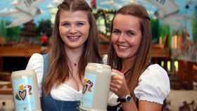 Models hold the official Oktoberfest beer mugs during a presentation in Munich