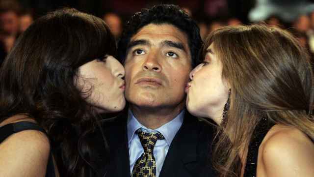 Maradona en el centro, siendo besado por sus hijas Giannina Dinorah (izq) y Dalma Nerea.
