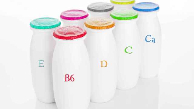 Yogurt containers healthy vitamin drink on white