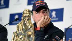 Un pensativo Carlos Sainz junto al trofeo de ganador del Dakar en Madrid.