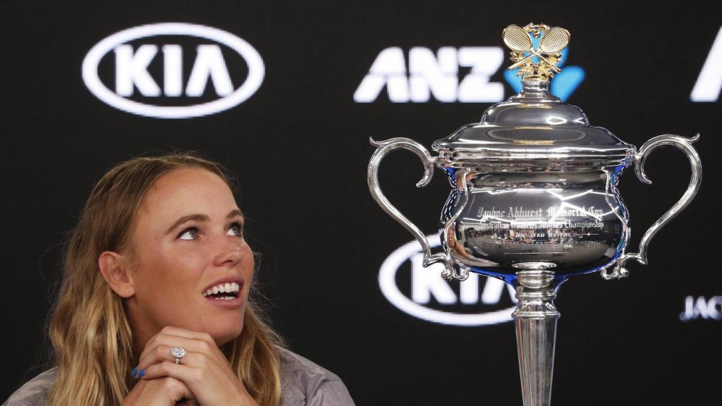 Wozniacki mira embelesada el trofeo de su primer grande.