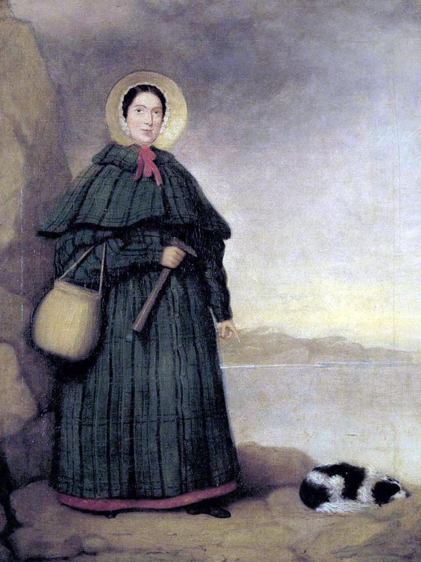 Retrato de Mary Anning con su perro Try y el afloramiento Golden Cap al fondo.
