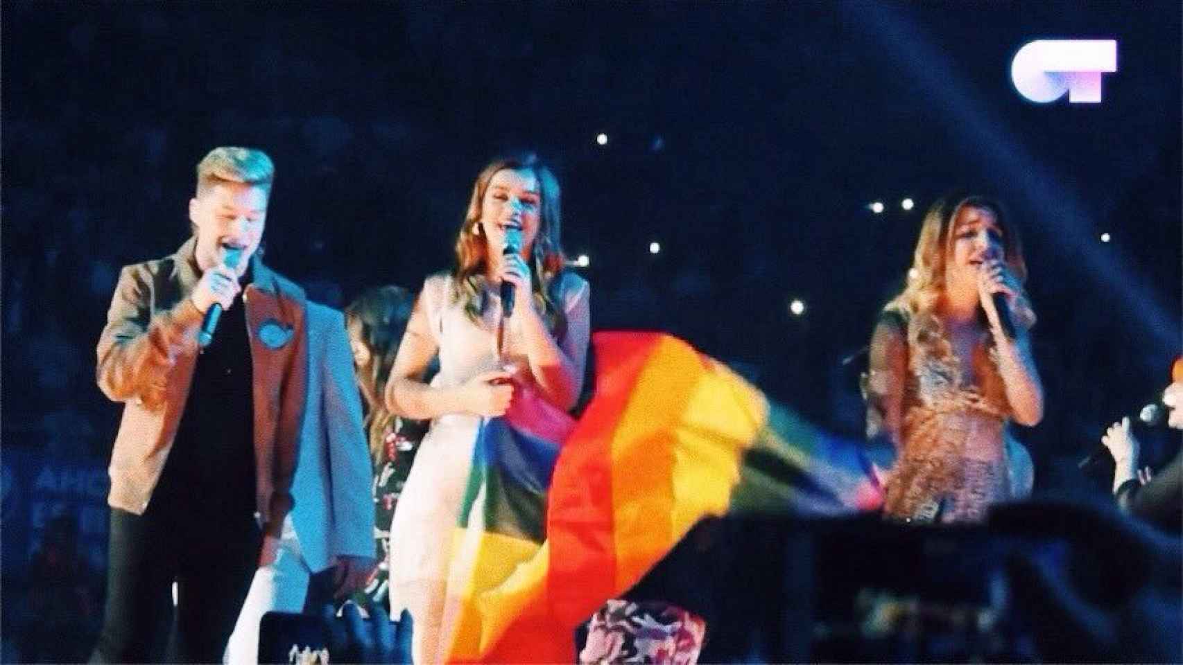 Amaia y Raoul con una bandera LGTB en el escenario del concierto de OT en Madrid.