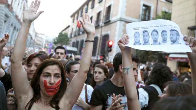 Una mujer con una marca de una mano en la cara levanta los brazos en una de las manifestación en contra de la sentencia de La Manada.