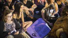 Mujeres sentadas con una de las pancartas / Jorge Barreno.