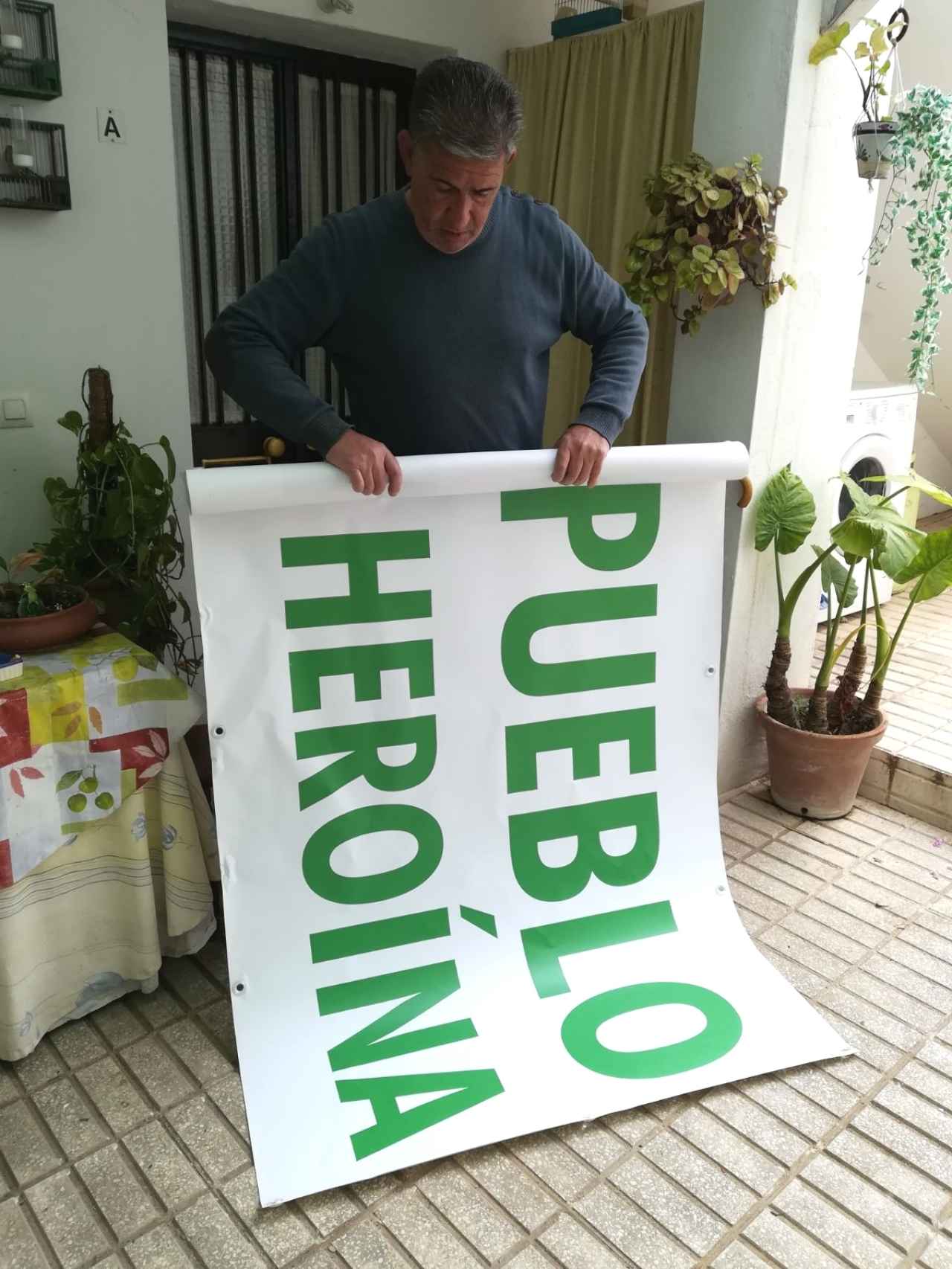 Manuel González, de 61 años, enrrolla la pancarta con la que ha encabezado dos protestas en su pueblo, Arcos de la Frontera (Cádiz). En ella se lee 'Por un pueblo limpio de heroína'
