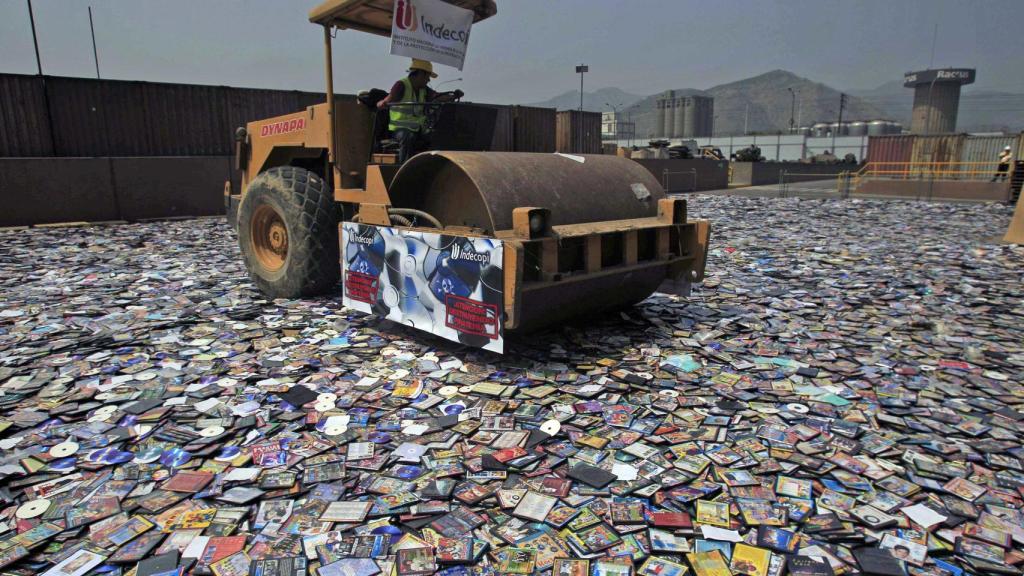 Destrucción de DVDs piratas incautados en Perú.