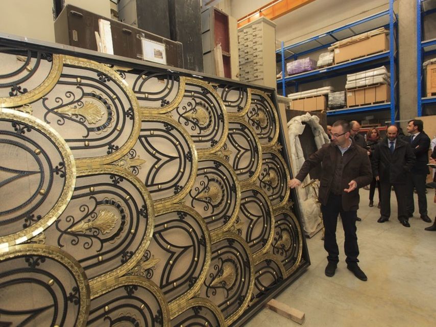 El artesano metalista muestra la reja del desaparecido Alcalá 10, almacenado por OHL.