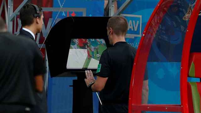 FILE PHOTO: Referee Mark Geiger reviews an offside decision on VAR in World Cup match South Korea vs Germany - Kazan Arena, Russia - June 27, 2018