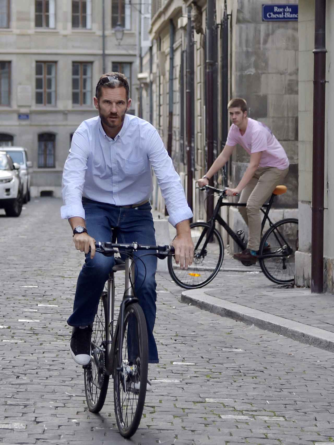 Padre e hijo en bicicleta por la calles de Ginebra.