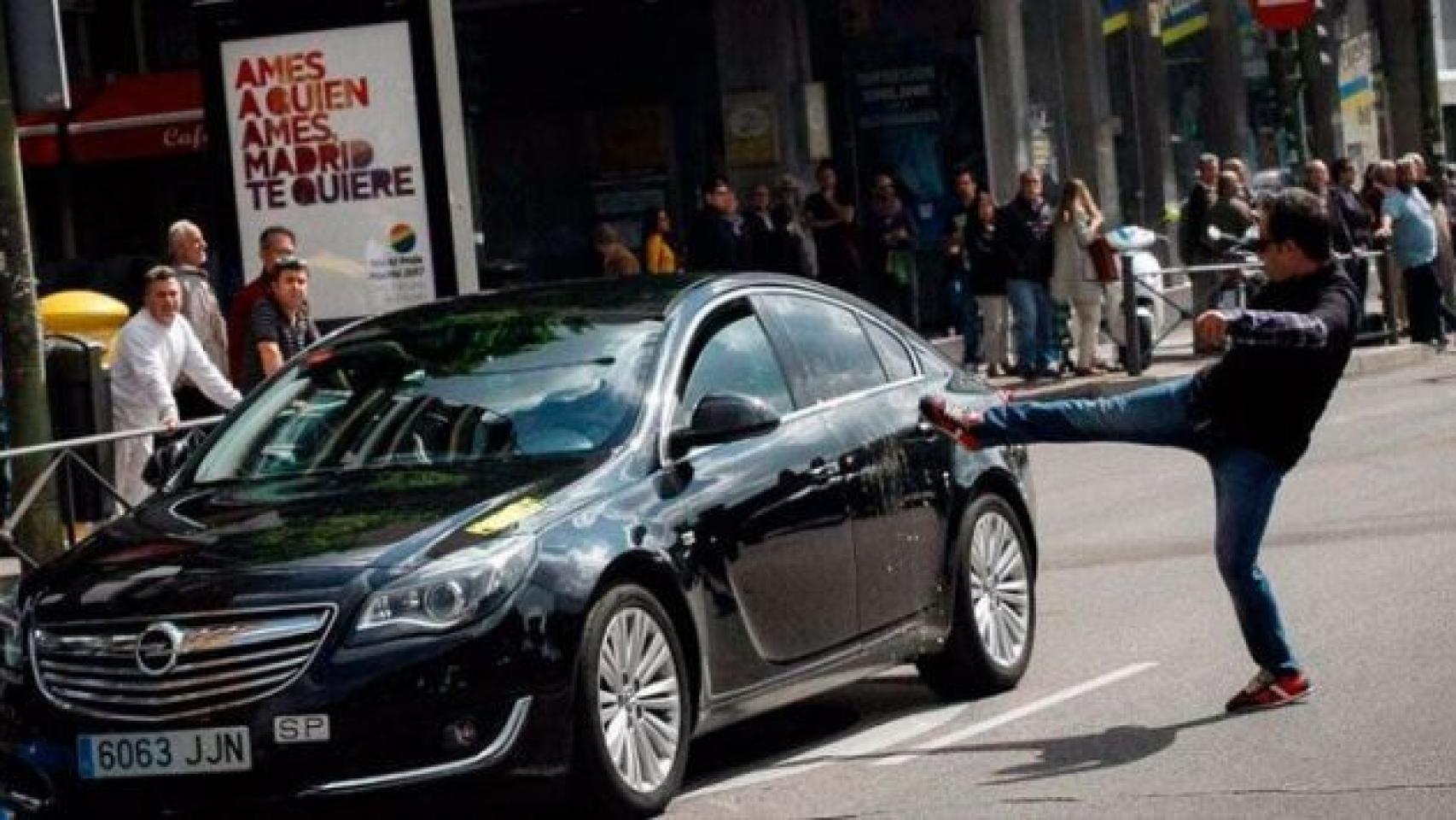 Un taxista en huelga propina una patada a un coche con licencia VTC .