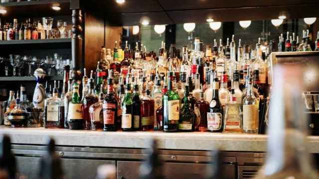 La barra de un bar repleta de bebidas alcohólicas.