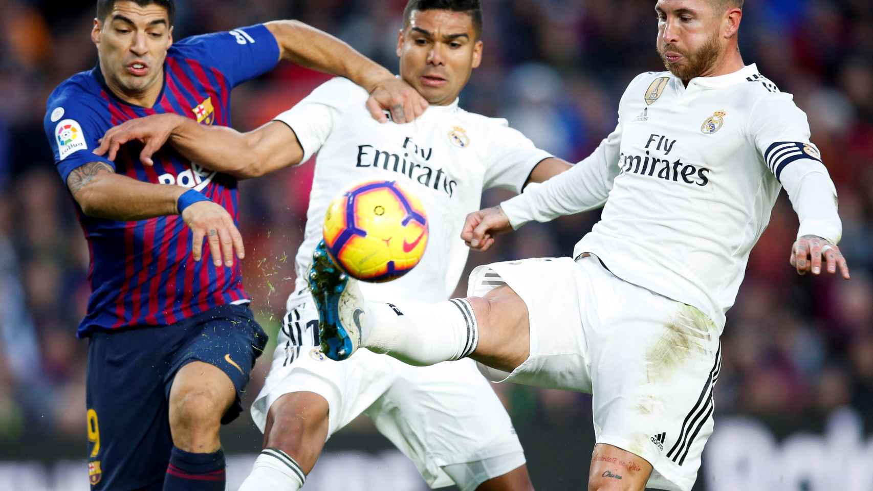 Sergio Ramos y Casemiro pelean un balón con Luis Suárez