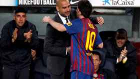 FILE PHOTO: Barcelona's Lionel Messi celebrates his fourth goal with coach Pep Guardiola against Espanyol during their Spanish first division soccer match at Nou Camp stadium in Barcelona