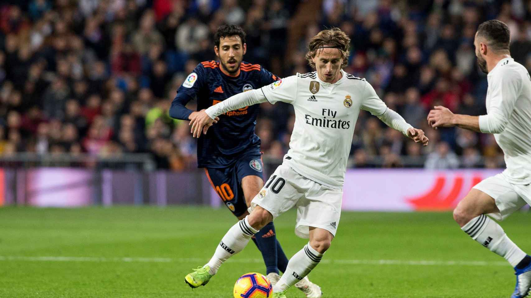 Luka Modric lucha por el balón frente al centrocampista del Valencia, Dani Parejo