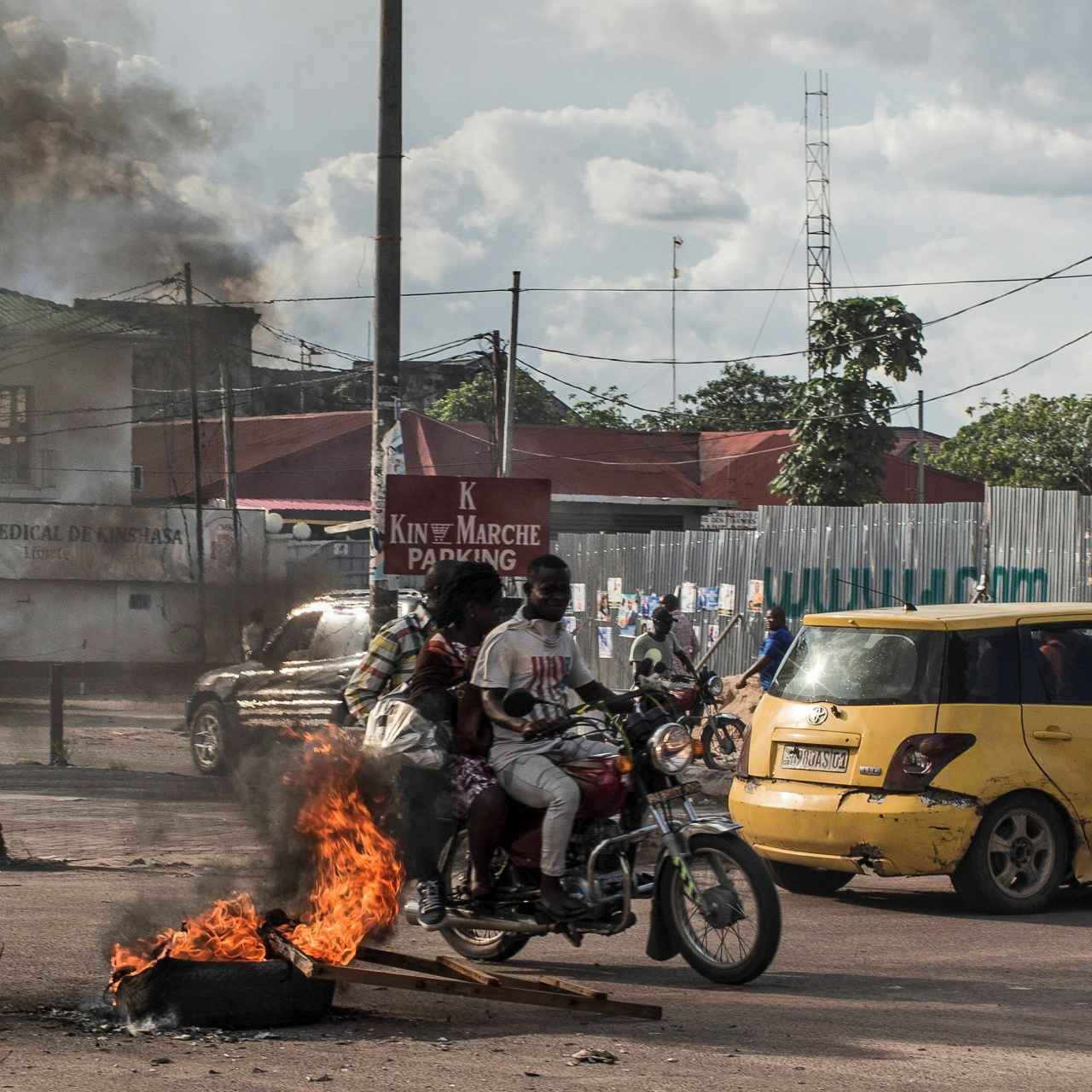 Un neumático arde durante las protestas civiles por el aplazamiento de las elecciones.