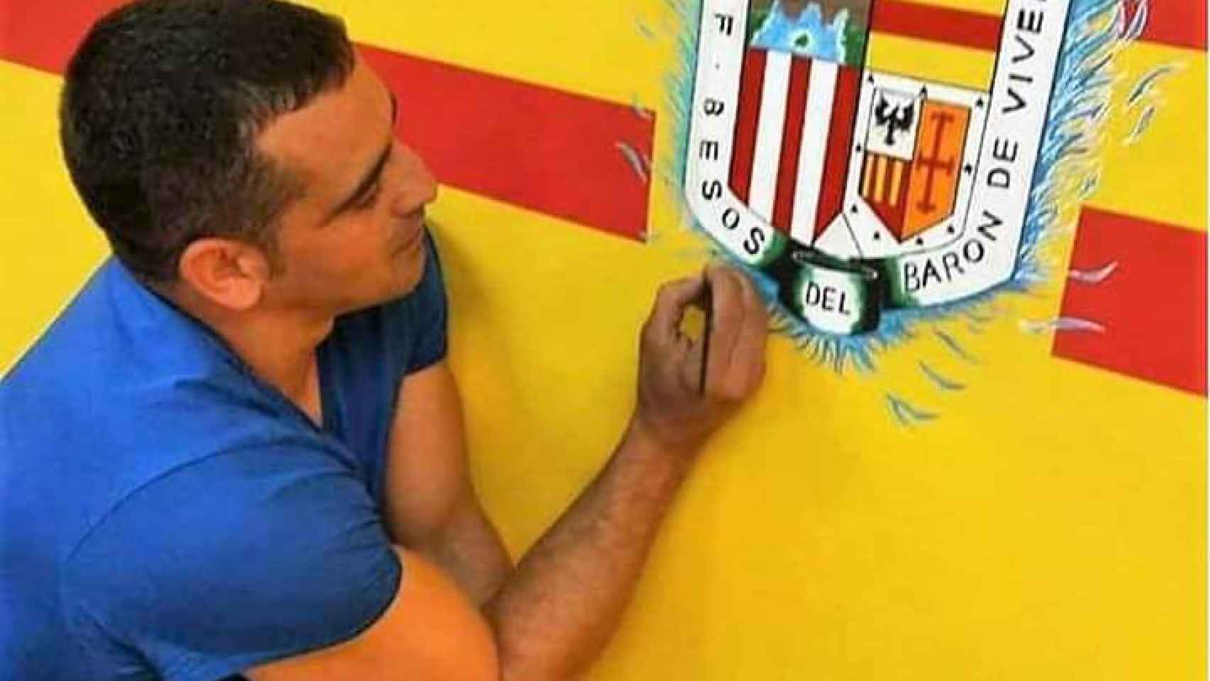 Edu Colmena pintando el escudo del equipo de fútbol de su barrio