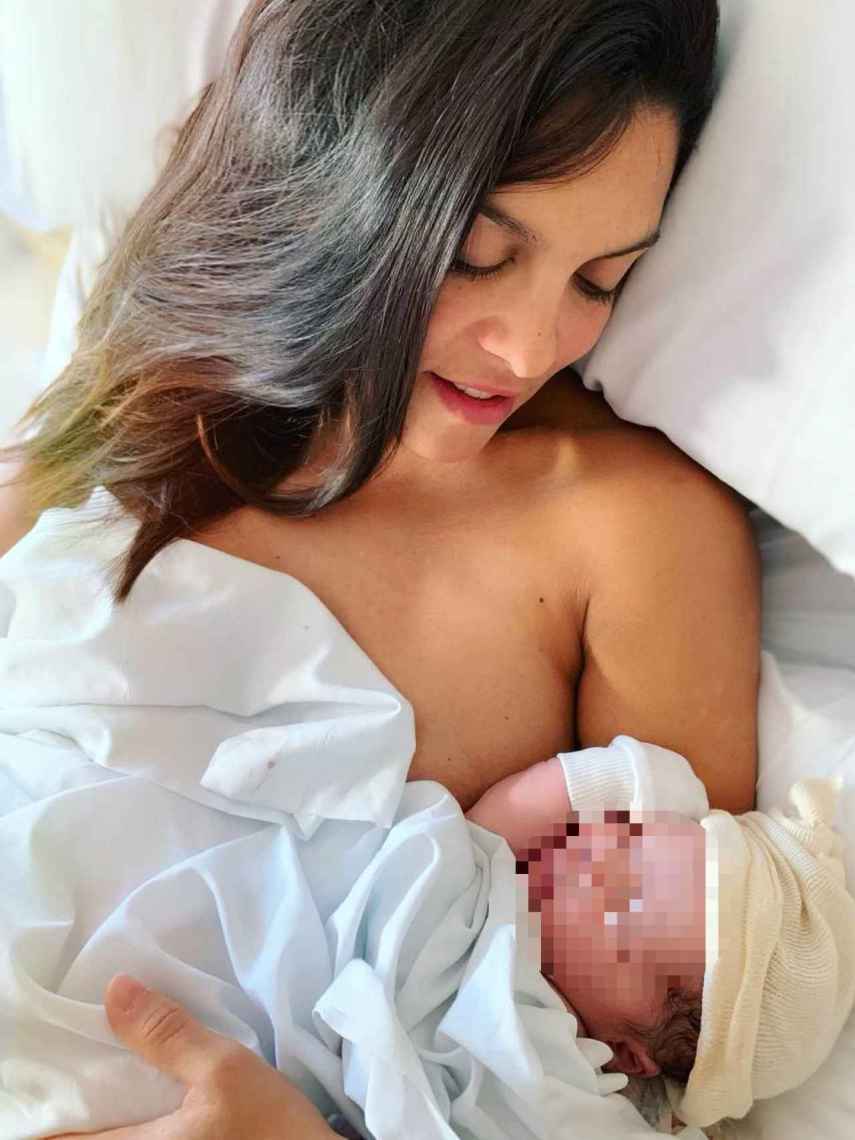 Lorena Castell posa sonriente mirando a su recién nacido.