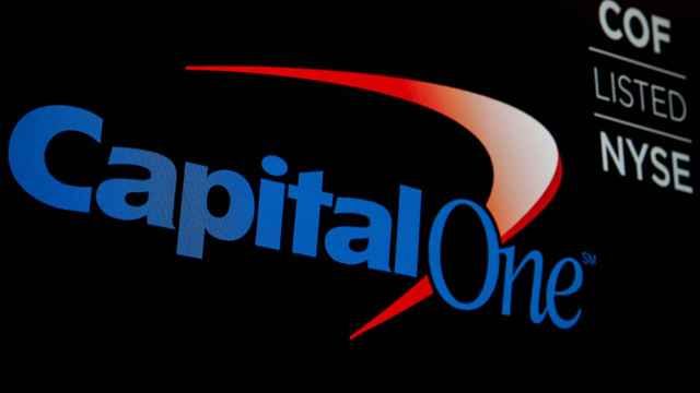 FILE PHOTO: The logo and ticker for Capital One are displayed on a screen on the floor of the NYSE in New York