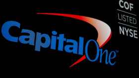 FILE PHOTO: The logo and ticker for Capital One are displayed on a screen on the floor of the NYSE in New York