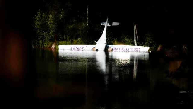 Norway's first battery-powered aircraft piloted by Avinor Chief Executive Dag Falk-Petersen is seen partly submerged in a lake after crash-landing, in Nornestjonn, Arendal