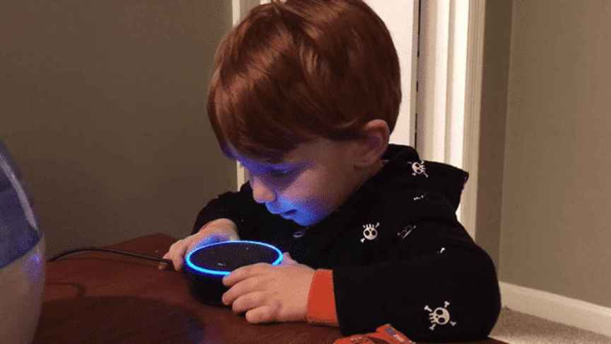 Un niño utiliza uno de los altavoces inteligentes de Amazon.