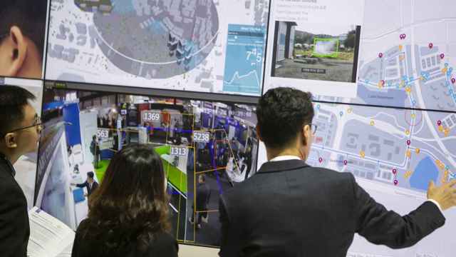 Asistentes a la Smart City Expo contemplan una demo tecnológica.