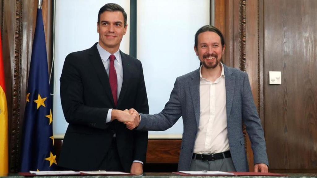 Sánchez e Iglesias estrechan sus manos durante el acto de la firma este lunes 30-D