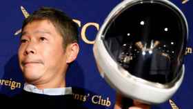 FILE PHOTO: Japanese billionaire Maezawa, founder and chief executive of online fashion retailer Zozo, who has been chosen as the first private passenger by SpaceX, poses for photos as he attends a news conference in Tokyo