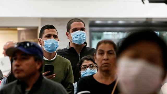 Transeúntes con mascarillas en el aeropuerto de Ciudad de México.