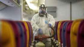 Un miembro de Thai Airways desinfecta un avión procedente de China.
