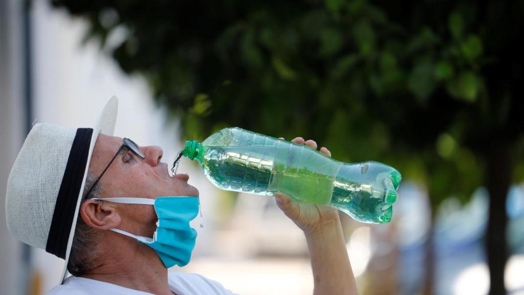 Un hombre se quita la mascarilla para beber agua este miércoles en Córdoba.