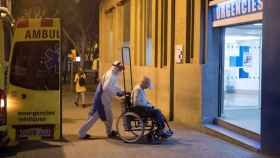 Un técnico sanitario traslada a un paciente contagiado a las urgencia de un hospital en Madrid.