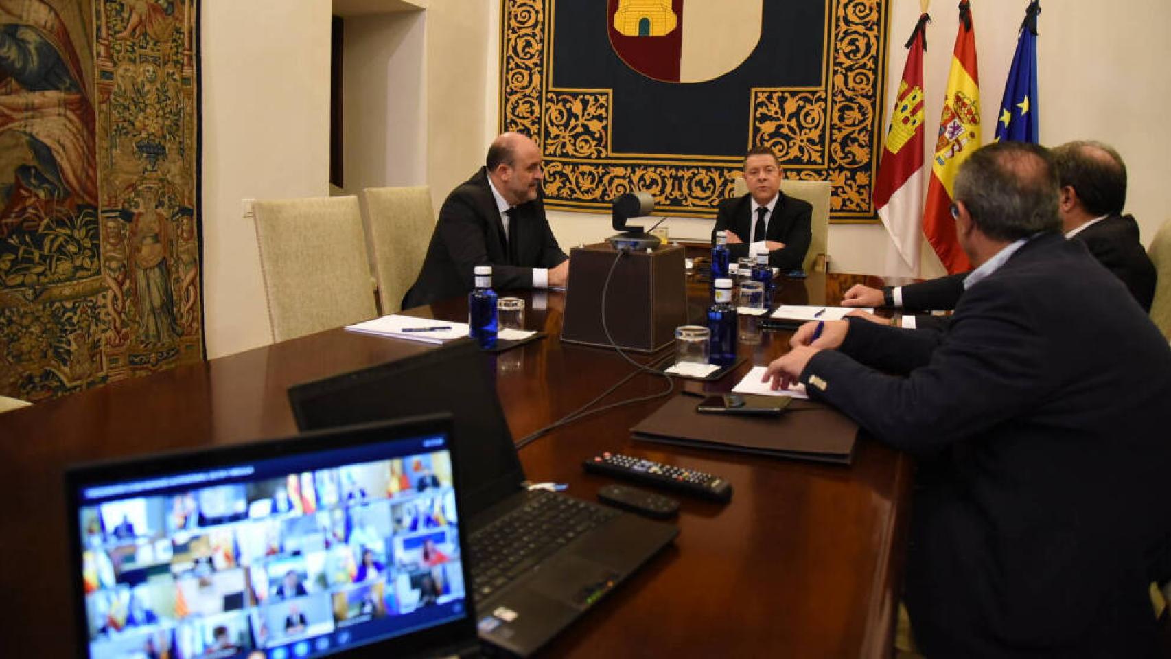 El presidente de Castilla-La Mancha, Emiliano García-Page, y varios consejeros, este domingo en la videoconferencia con el presidente del Gobierno, Pedro Sánchez